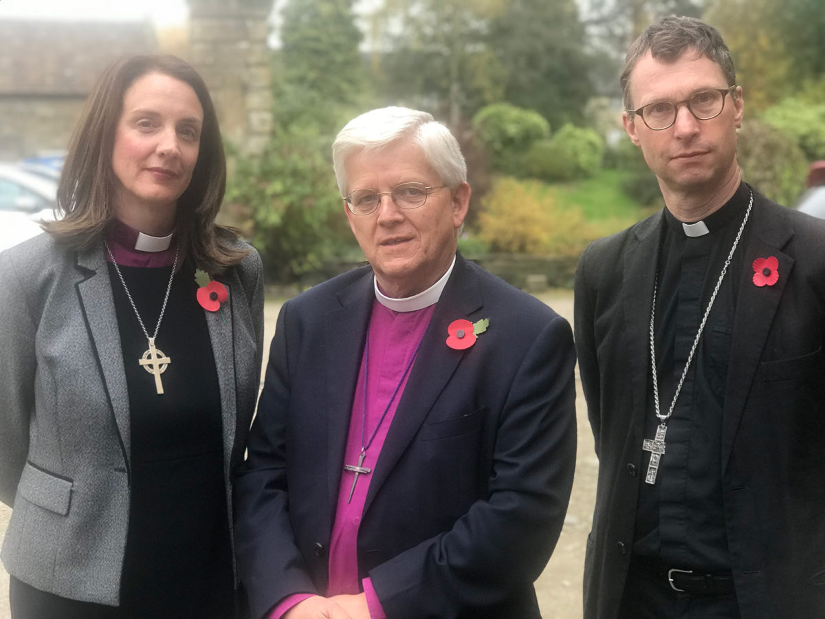 Three Bishops with remembrance poppies outside of Blackburn Cathedral